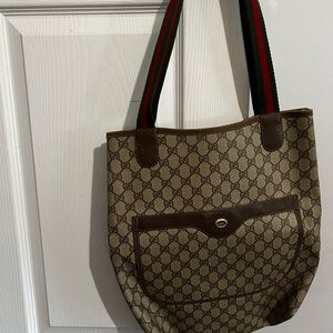 Gucci tote.  Roomy inside. Large pocket on outside.